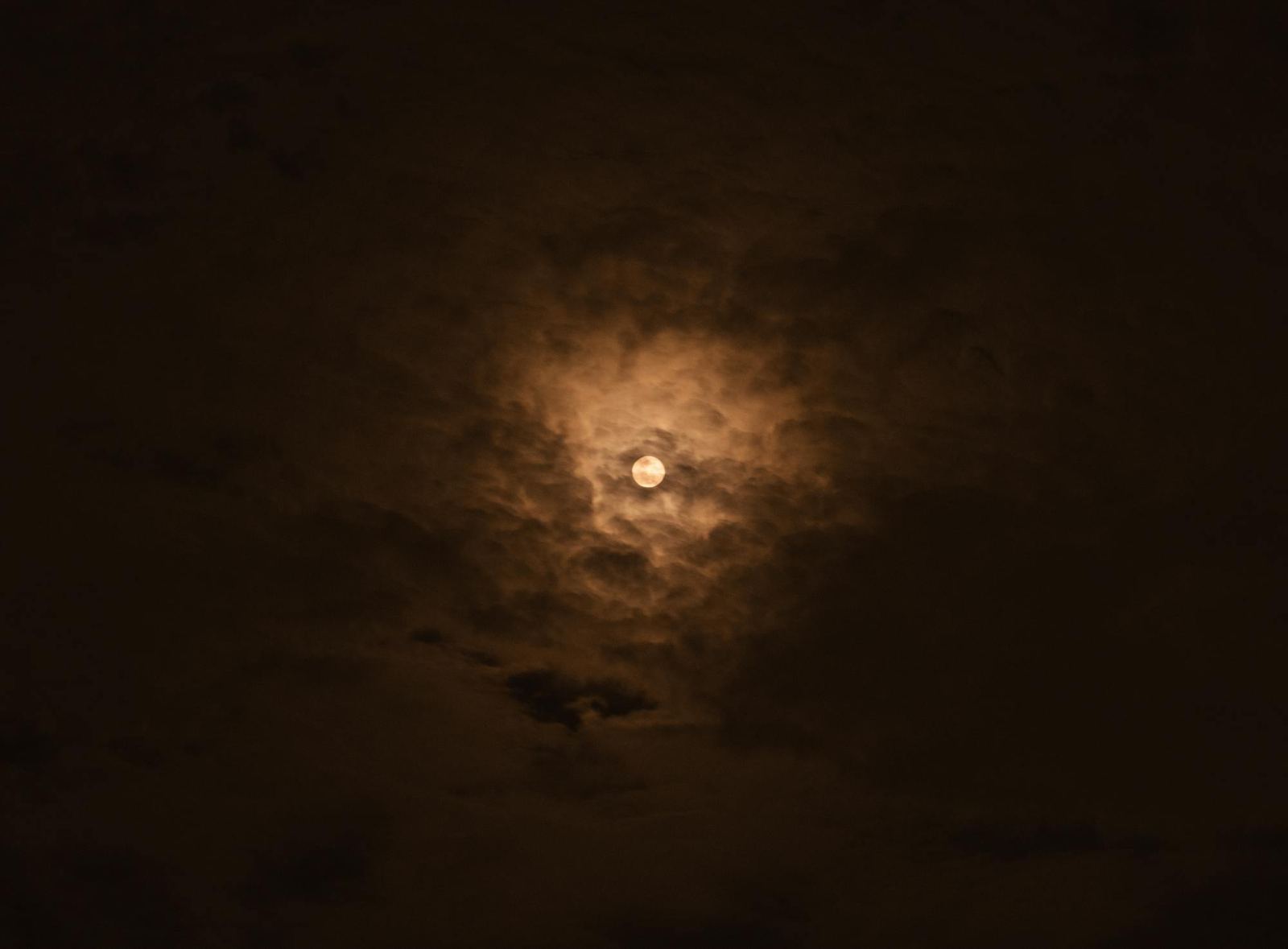 The moon behind thin cloud over Tokyo